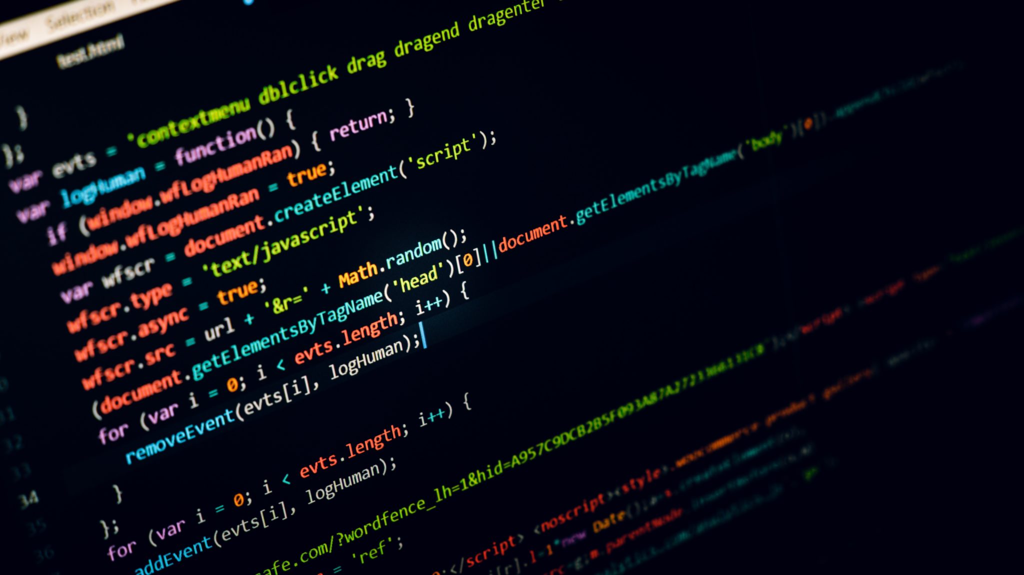 Computer screen filled with colorful JavaScript source code