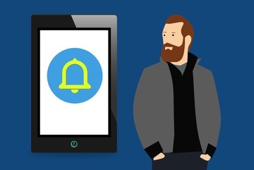Flat illustration of a bearded man beside a tablet showing a notification bell icon
