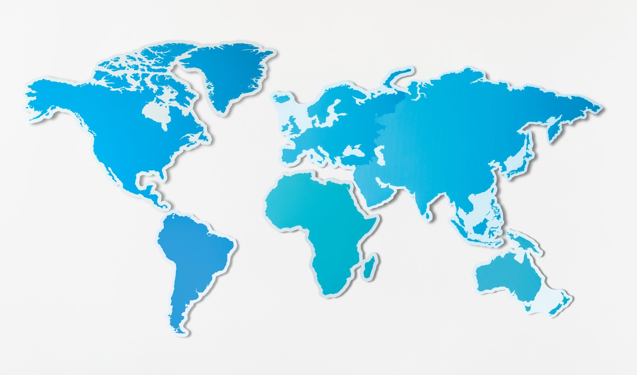 Stylized blue paper cut-out world map on a white background