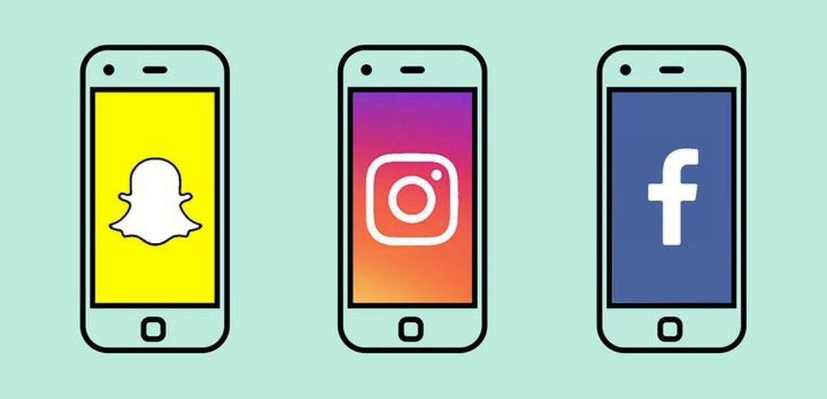 Three smartphones showing Snapchat, Instagram and Facebook app icons on screen