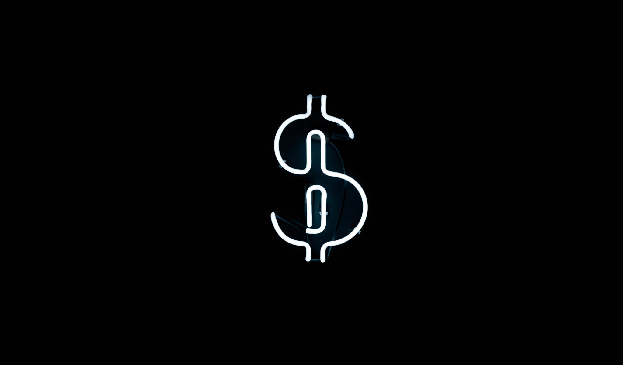 Glowing white neon dollar sign on a black background